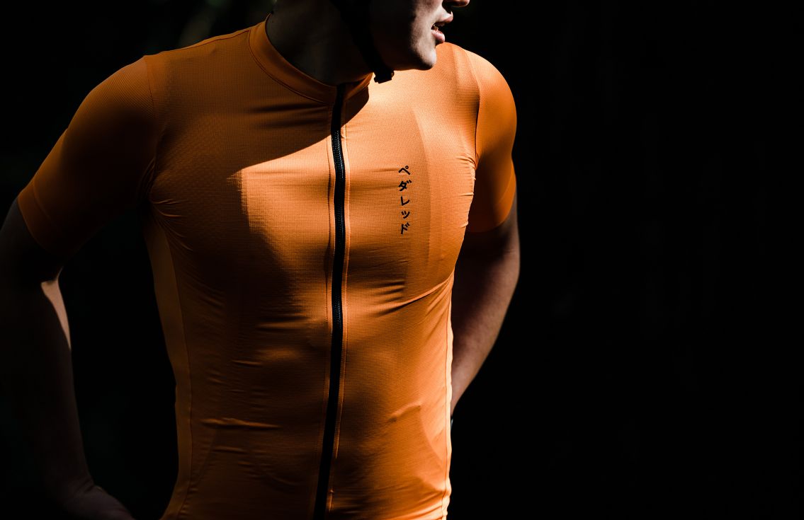 men cycling jersey road orange mirai in action pedaled