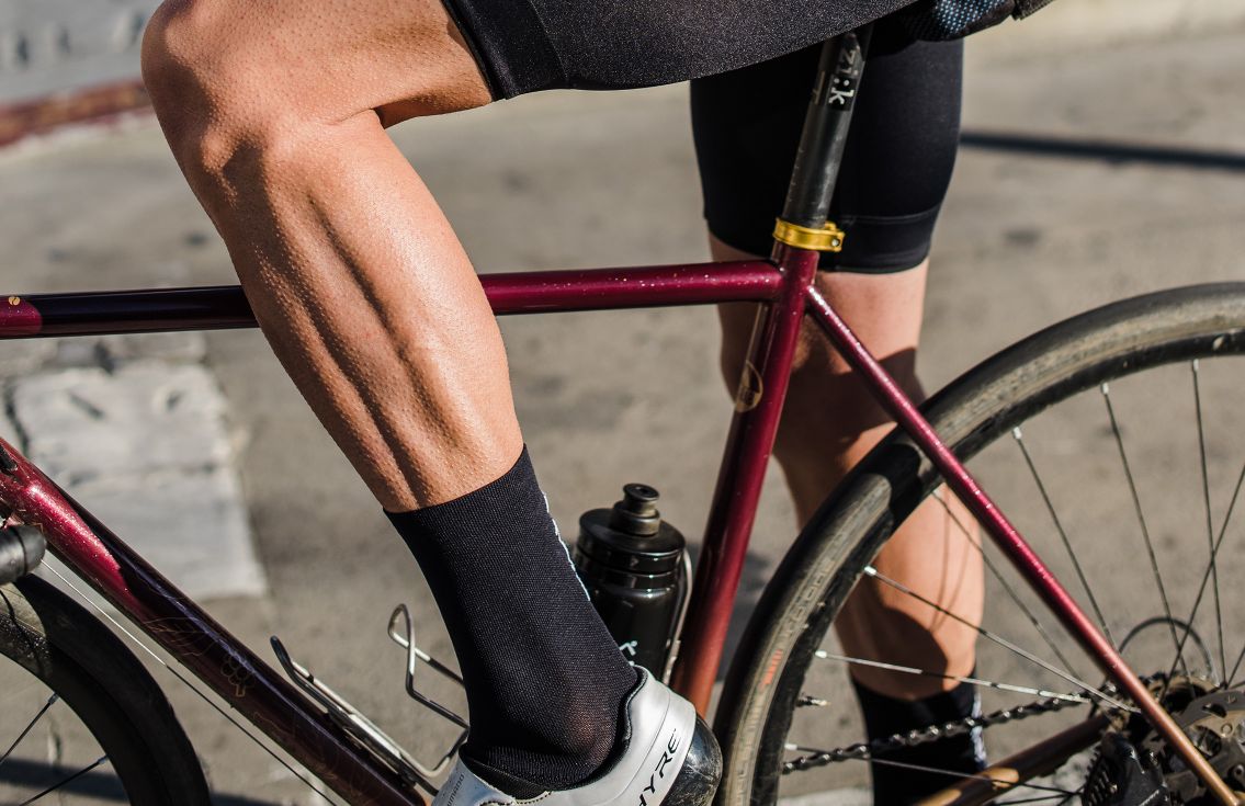 men cycling socks logo black mirai in action pedaled