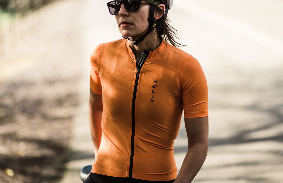 women cycling jersey road orange mirai in action pedaled