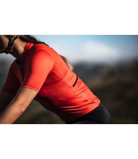 woman lightweight cycling jersey brick red mirai pedaled action